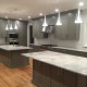 Contemporary gray kitchen with island and range hood