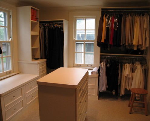 Contemporary white closet with island