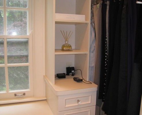 Contemporary white closet with island drawer