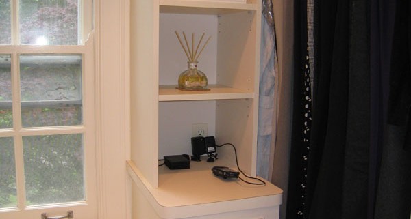 Contemporary white closet with island drawer