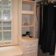 Contemporary white closet with island drawer