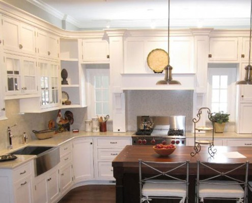 Contemporary white kitchen with range hood and island