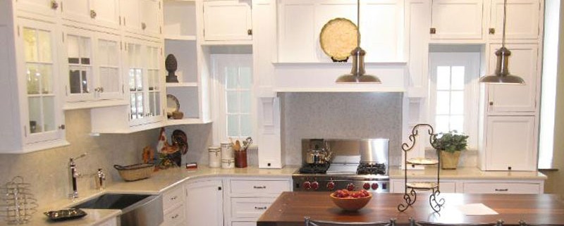 Contemporary white kitchen with range hood and island