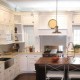 Contemporary white kitchen with range hood and island